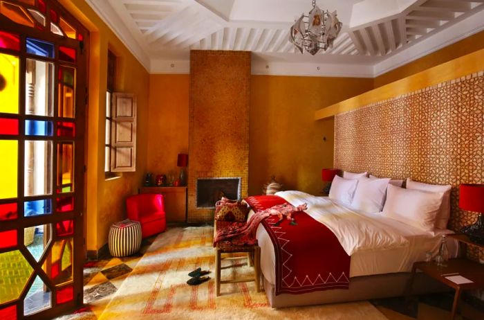 The interior of an El Fenn Ochre guest room, featuring a large stained glass window