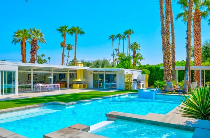 Spacious rectangular pool surrounded by palm trees in Palm Springs