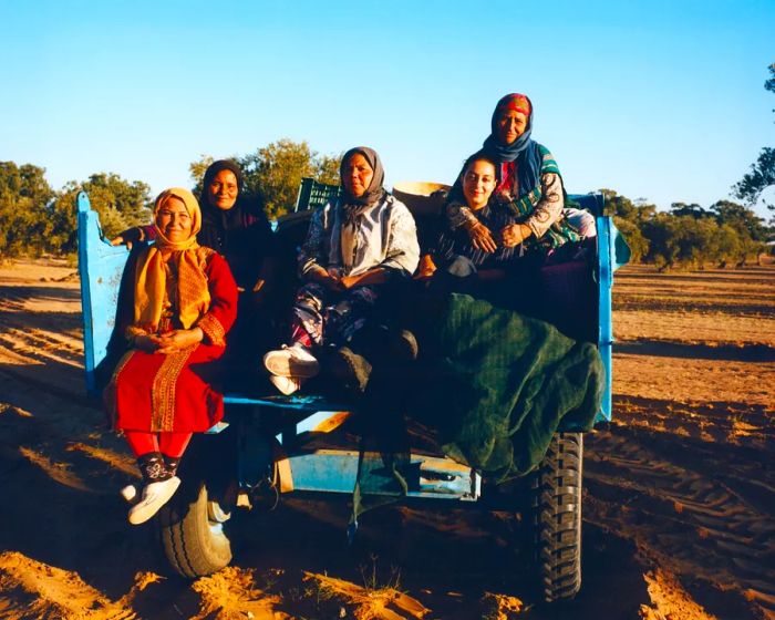 Sarah Ben Romdane relaxes in the back of a truck alongside a few employees.