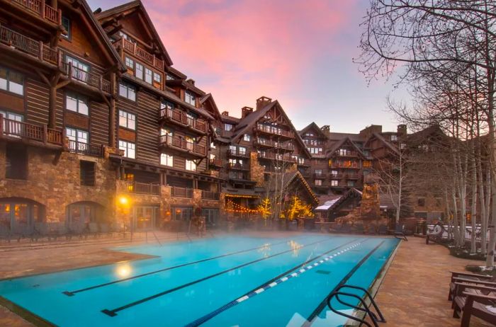 Exterior view of the Ritz-Carlton Bachelor Gulch, featuring the pool in the foreground.