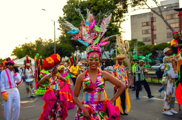 Woman in vibrant costume and headdress during La Feria de Cali