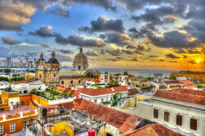 A stunning sunset view over the city skyline, showcasing red-tiled roofs.