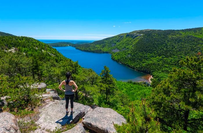 A Hiker at the Summit of a Hill in Acadia National Park, Maine