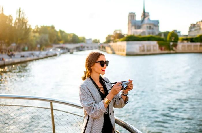 A woman capturing moments while enjoying a river cruise.