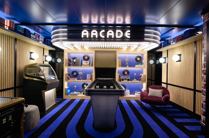 Game room featuring blue-and-black striped carpets, an arcade sign, and a jukebox