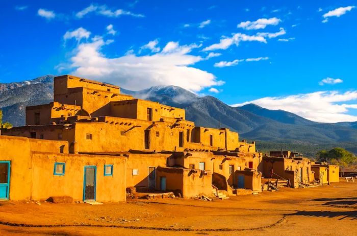 The Taos Pueblo with lush mountains in the background