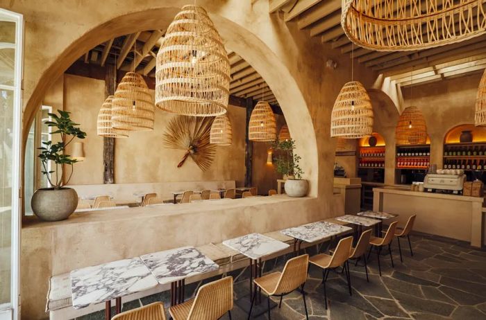 Interior view of Great White restaurant in L.A., showcasing marble tables and hanging basket lamps