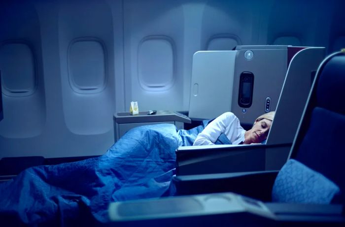 Passenger enjoying sleep in a Turkish Airlines business-class flatbed