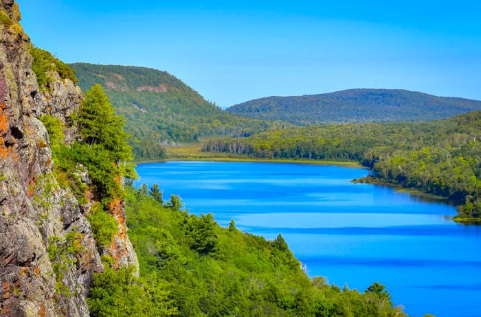 A vast lake nestled amidst forested hills