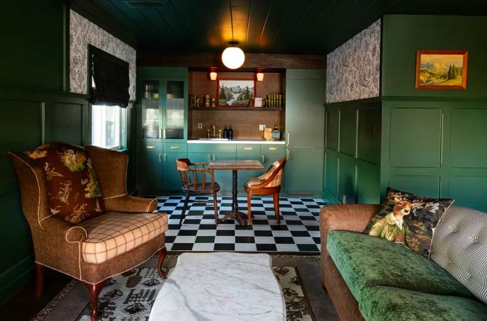 Interior of a cabin at Noble + Proper showcasing a black-and-white checkerboard floor and green walls