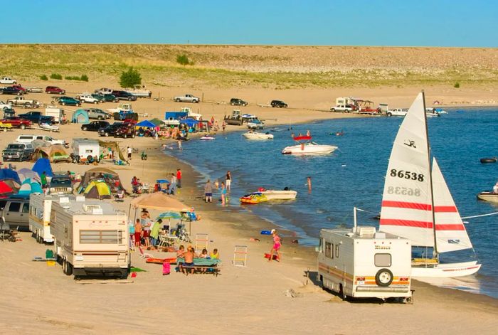 Lake McConaughy buzzes with RVs, cars, and people enjoying the beach, boating, and wading.