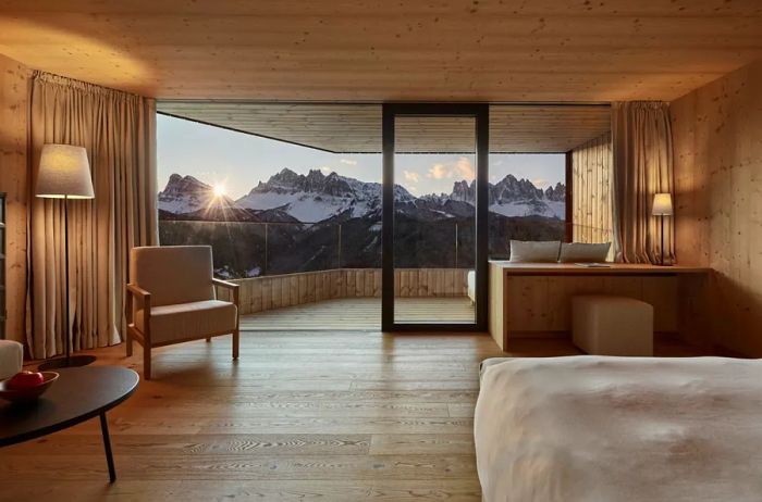 This suite at Forestis, nestled in Italy's Dolomites, boasts a private balcony offering breathtaking mountain views.