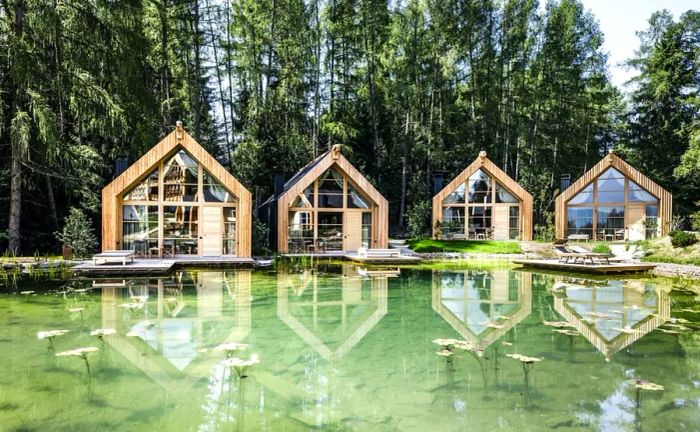 Adler Lodge Ritten features cozy A-frame chalets crafted from wood.