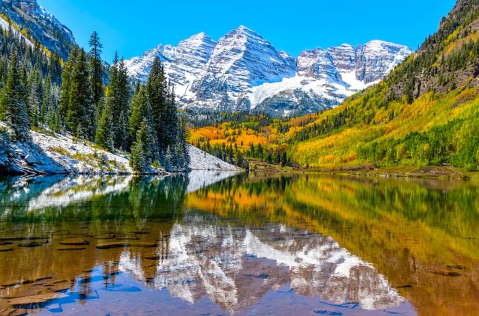 Snow-covered mountains towering over a serene lake