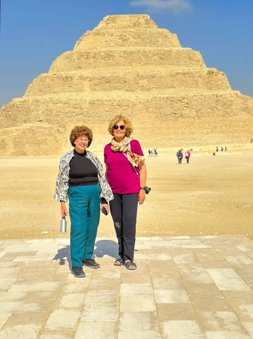 Ellie Hamby and Sandy Hazelip posing in front of an Egyptian pyramid.