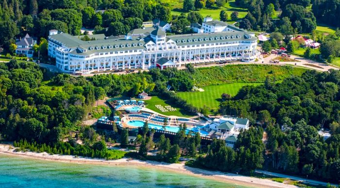 Aerial view of the Grand Hotel and its pool on Mackinac Island, adjacent to the shores of Lake Huron.