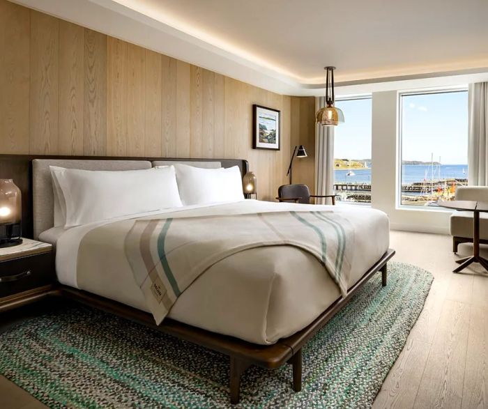 A glimpse of a guest room at the Muir Hotel in Halifax, featuring a tartan blanket specially designed for the hotel on the bed.