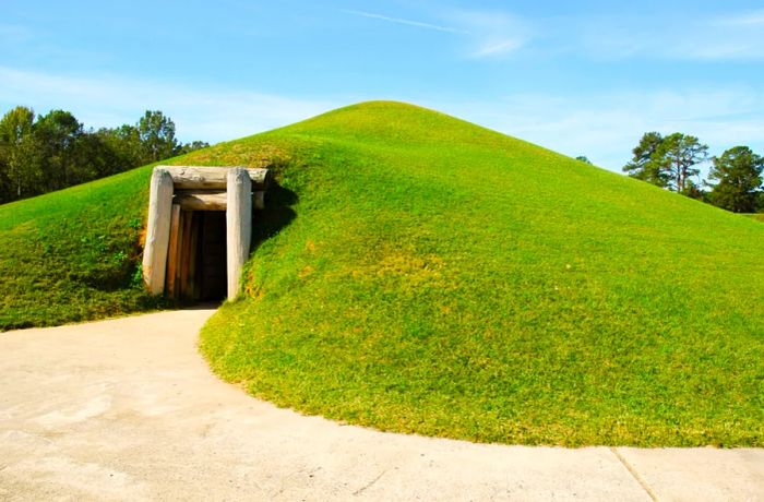 A green mound with a rectangular entryway at Ocmulgee Mounds Historical Park