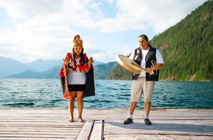 Two members of the Klahoose Nation on a wooden deck by Klahoose Wilderness Resort