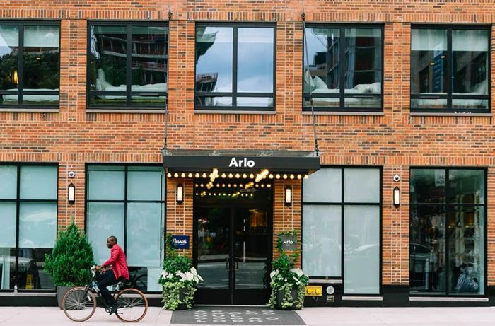 The brick facade of Arlo SoHo features rows of expansive windows