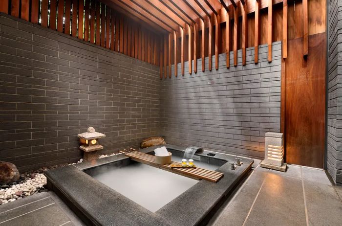 A stylish, minimalist indoor hot spring tub at Water House