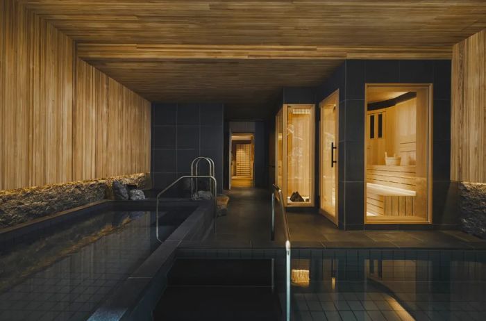 The sauna area within the Six Senses Kyoto spa is elegantly designed with wood and dark stone finishes.