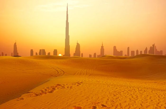 A view of Dubai's skyline at sunset, captured from the desert