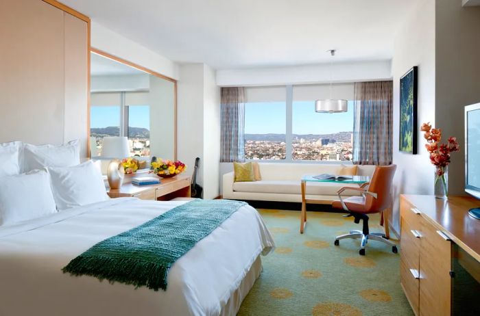 Interior of a guest bedroom offering a city view at the Ritz Carlton Los Angeles.