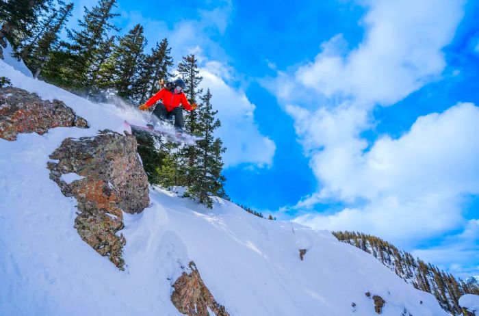 A snowboarder relishing the slopes at Taos Ski Valley.