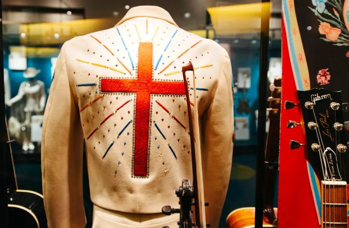 One exhibit at the Country Music Hall of Fame features a striking view of a white jacket adorned with a red cross and rhinestones.