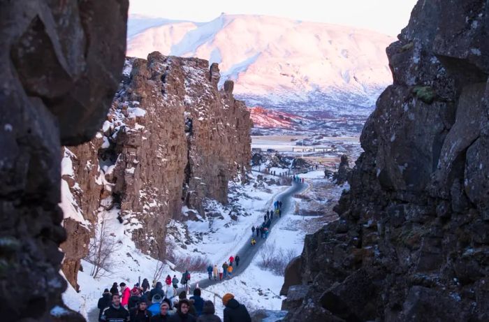 ICELAND - DECEMBER 09: Tourists explore a rift in Þingvellir National Park, part of the well-known Golden Circle Tour. (Image by Melanie Stetson Freeman/The Christian Science Monitor via Getty Images)