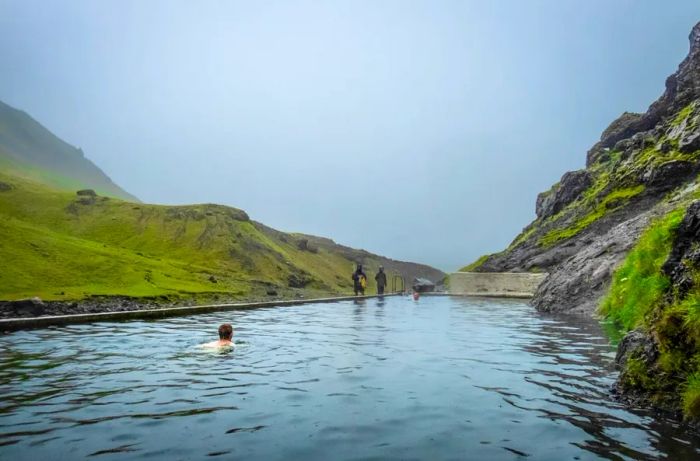 A man-made thermal pool in Southern Iceland draws water from an underground hot spring, reaching temperatures close to 85 degrees F. (Photo by John Fredricks/NurPhoto via Getty Images)