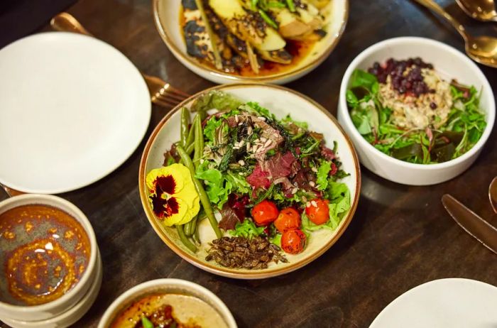 A table filled with Indigenous-inspired dishes at the James Beard Award-winning restaurant Owamni, Minnesota