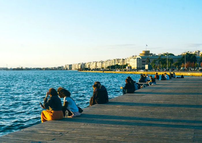 People relaxing along Thessaloniki's waterfront promenade.