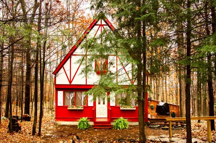 Charming red and white chalet-style cabin in the woods