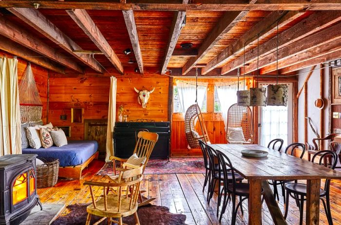 Interior view of a rustic cabin featuring wood paneling and a beamed ceiling in Upstate New York