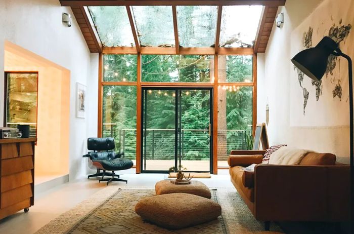 Interior of a cabin featuring a glass wall and skylight