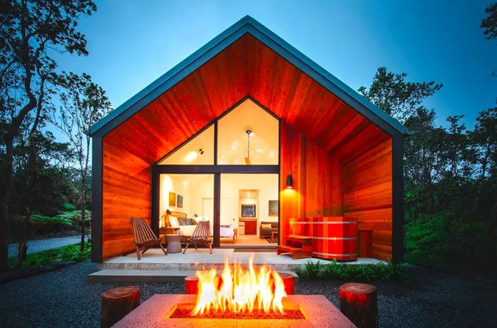 Contemporary cabin with an outdoor gas fireplace in the foreground