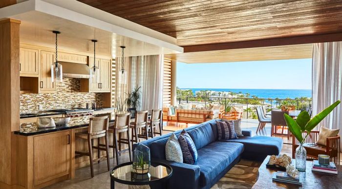 A spacious sofa and a kitchen counter with seating in a room at Chileno Bay