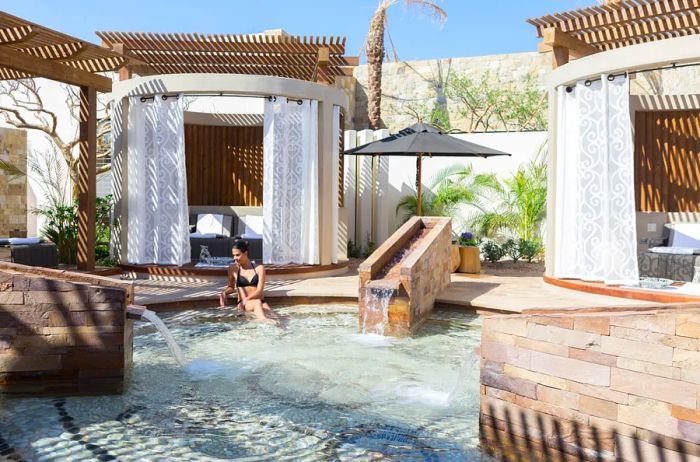 An outdoor reflexology pool featuring a woman relaxing in it