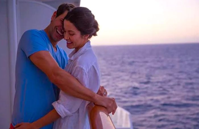 A couple enjoying an embrace on their balcony