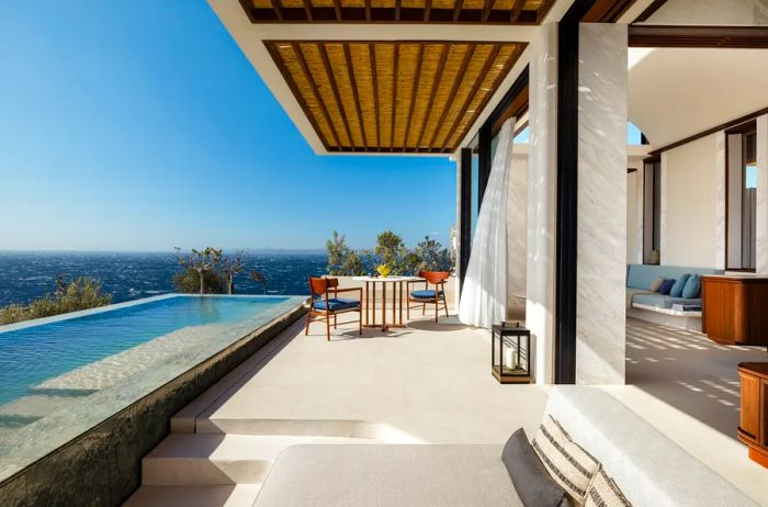 The terrace of this guest room at One&Only Kéa Island features a spacious private pool overlooking the sea.