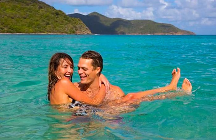 A couple enjoying playful moments in the azure ocean