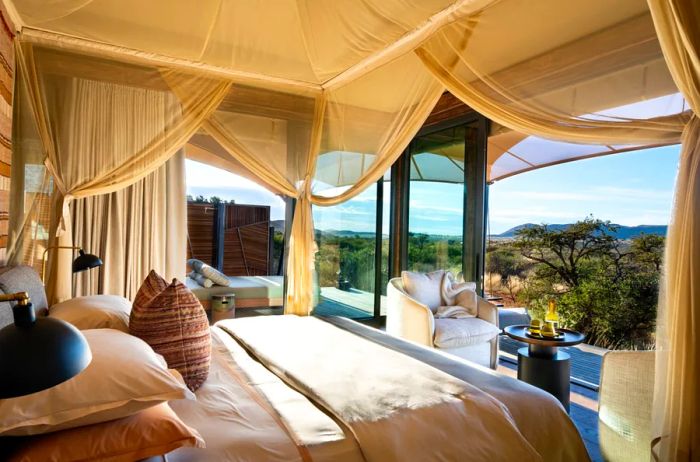 The beige interior of a Loapi bedroom with a stunning view of the landscape.