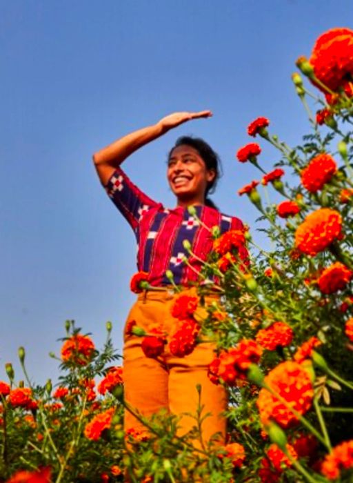 Sana Javeri Kadri surrounded by orange flowers