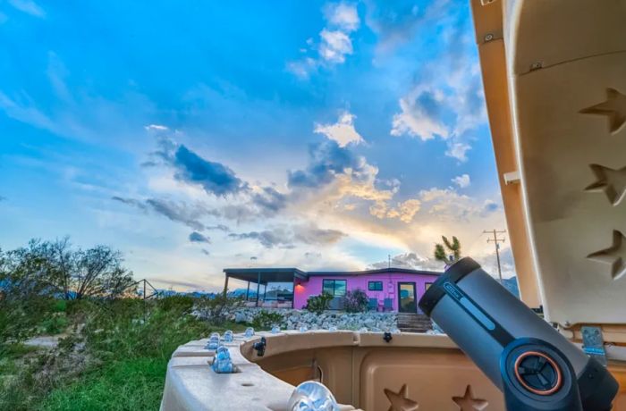 Telescope observatory located near a pink Airbnb cabin in Joshua Tree