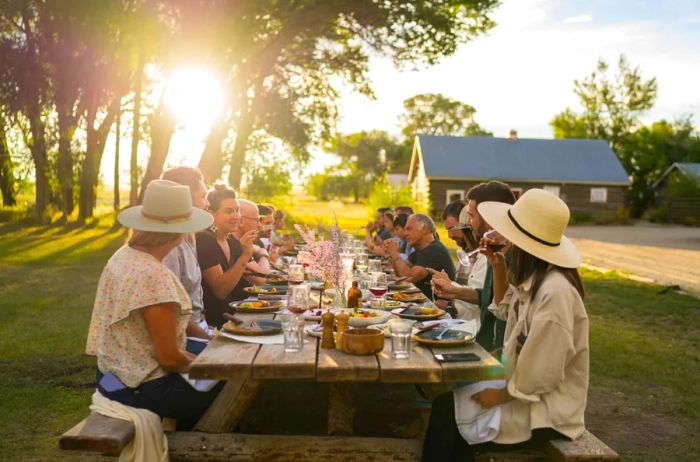 Long table set for outdoor diners enjoying a Harvest Weekend feast