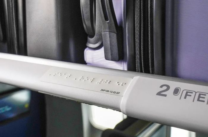 Braille signage on an overhead compartment in a United aircraft