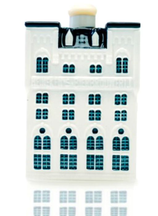 Delftware ceramic miniature depicting the Heineken brewery in Amsterdam. The ornament features a white building with blue windows.