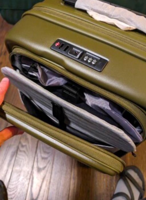 Lojel Cubo Small olive green carry-on suitcase with partially open front laptop sleeve